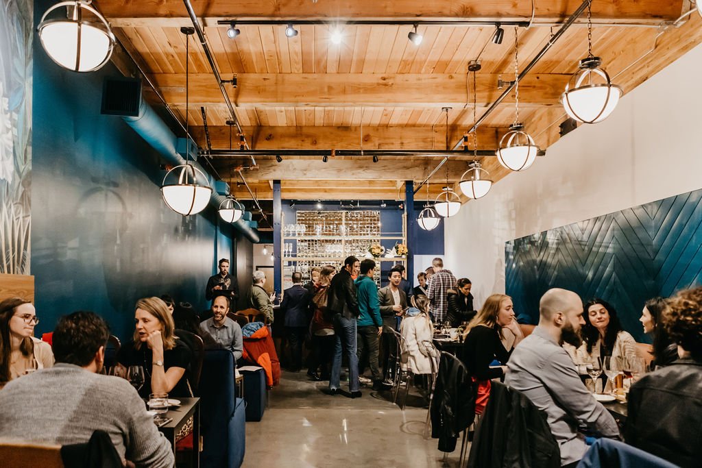 Guests sharing food and wine at Stem Wine Bar